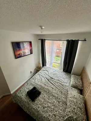a small bedroom with a bed and a window at DT Townhome 1BR steps to transit in Toronto