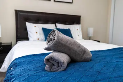 a stuffed animal is laying on a bed at Joyful Haven|KingBed|Air Hockey| 10 mins to Falls in Thorold