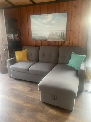 a living room with a couch and a painting on the wall at Lakefront Lake Erie with Amazing Views 3BR Pet Friendly 1 HR from Hamilton and Niagara
