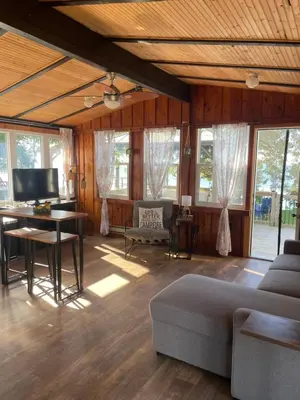 a living room with a couch and a table at Lakefront Lake Erie with Amazing Views 3BR Pet Friendly 1 HR from Hamilton and Niagara