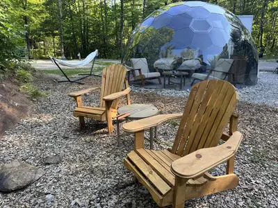 three chairs and a soccer ball in a tent at Rare Mirrored Glamping Dome in Severn