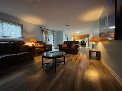 a living room with a couch and a table at Renaissance Guest House in Oshawa