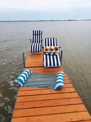 two chairs and a dock on a body of water at Waterfront Comfy Guesthouse, PEC in Carrying Place