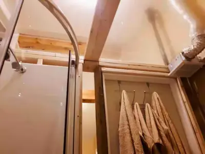 a closet with a glass door and some towels at Waterfront Comfy Guesthouse, PEC in Carrying Place