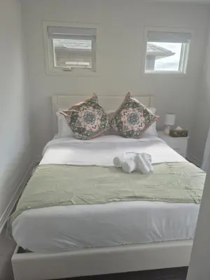 a bed with a stuffed animal on top of it at Stylish 3BR 2.5 Bath Townhouse with Patio and parking in Mississauga