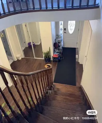 a stairway with a wooden railing and a door at Private comfortable M1 bedroom in Mississauga