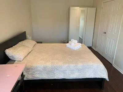 a bedroom with a bed with two towels on it at Private comfortable M1 bedroom in Mississauga