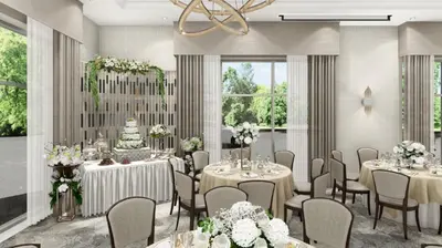 a banquet room with tables and chairs and a chandelier at Staybridge Suites Aurora East by IHG in Aurora