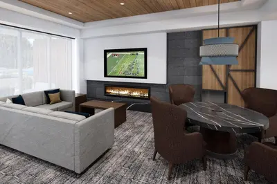 a living room with a couch and a fireplace at Staybridge Suites Aurora East by IHG in Aurora