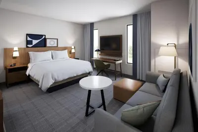 a hotel room with a bed and a couch at Staybridge Suites Aurora East by IHG in Aurora