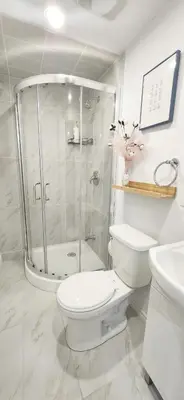 a bathroom with a shower and a toilet and a sink at Pacific Mall Bright & Cozy Rooms with Privated Bathrooms in Toronto