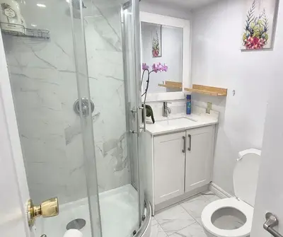 a bathroom with a shower and a toilet and a sink at Pacific Mall Bright & Cozy Rooms with Privated Bathrooms in Toronto