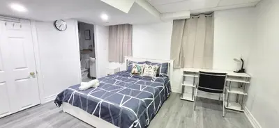 a bedroom with a bed and a table and chairs at Pacific Mall Bright & Cozy Rooms with Privated Bathrooms in Toronto