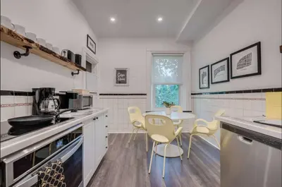 a kitchen with a table and chairs in it at Modern Industrial Suite w Private Patio - The Roland in Toronto