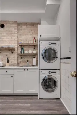 a kitchen with a washing machine and a washer at Modern Industrial Suite w Private Patio - The Roland in Toronto