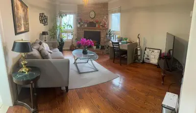 a living room with a couch and a table at Private bedroom 202 in Mississauga