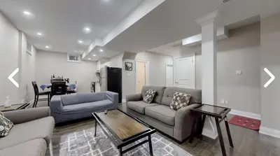 a living room with two couches and a table at Heaven on Earth in Ajax