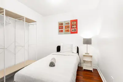 a bedroom with two beds and a glass wall at Luxe 3BR 2 Bath Condo Steps from Square one Mall in Mississauga