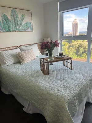 a bedroom with a bed with a table and a window at Lakeview in Toronto