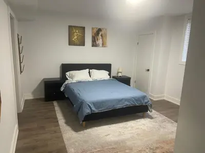 a bedroom with a bed and two pictures on the wall at Self contained lower level 1 Bedroom apartment in Oshawa
