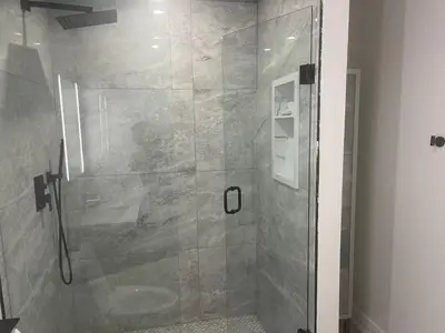 a shower with a glass door in a bathroom at Self contained lower level 1 Bedroom apartment in Oshawa