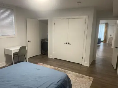 a bedroom with a bed and a table and a desk at Self contained lower level 1 Bedroom apartment in Oshawa