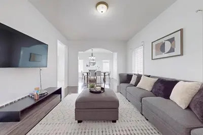 a living room with a couch and a table at Charming 4-bed Home Away From Home in Brampton, ON in Brampton
