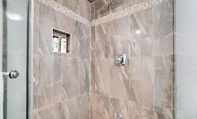 a bathroom with a shower with a glass door at Stylish Modern 2-bedroom Basement Suite in Brampton