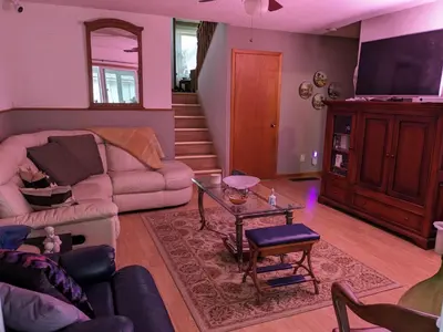 a living room with a couch and a table at Cozy home away from home, close to hospital, college, and university with free parking in Peterborough