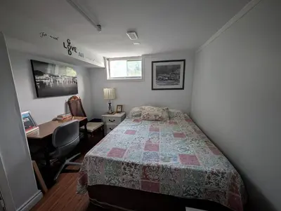 a bedroom with a bed and a desk and a computer at Cozy home away from home, close to hospital, college, and university with free parking in Peterborough