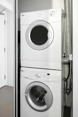 a washing machine and a dryer in a room at Modern Studio Retreat in Downtown Toronto in Toronto