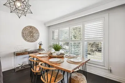 a dining room with a table and chairs and a window at Bright 3-BDRM House, Family Home & Parking, YYZ Airport in Mississauga