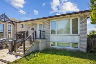 a house with a staircase in front of it at Bright 3-BDRM House, Family Home & Parking, YYZ Airport in Mississauga