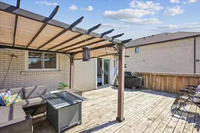a pergola on a patio with a couch and a table at Bright 3-BDRM House, Family Home & Parking, YYZ Airport in Mississauga