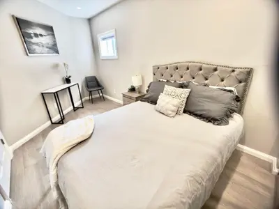 a bedroom with a large bed in a room at The Simple Escape, Walkout Basement on Ravine in Kitchener