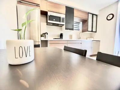 a table with a vase with the word love on it at The Simple Escape, Walkout Basement on Ravine in Kitchener