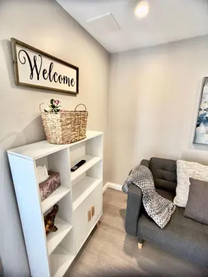 a living room with a couch and a chair at The Simple Escape, Walkout Basement on Ravine in Kitchener