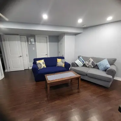 a living room with a couch and a coffee table at Cozy 2 Bedroom Suite, 5 mins from Thermea Spa in Whitby