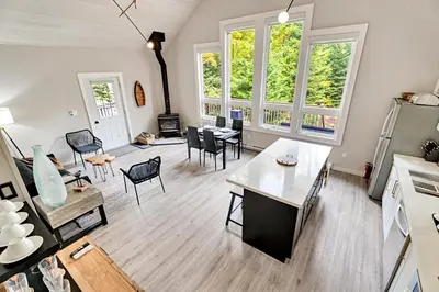 a living room with a table and chairs at Muskoka Waterfront Cottage with Canoes and Fire Pit in Huntsville