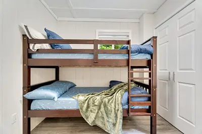 two bunk beds in a room with blue pillows at Muskoka Waterfront Cottage with Canoes and Fire Pit in Huntsville