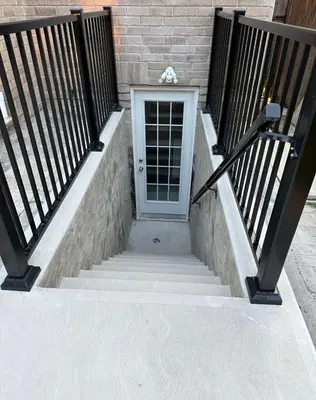 a set of stairs with a door and a building at Beautiful&Spacious 2 Bedroom Basement Family Suite in Bradford
