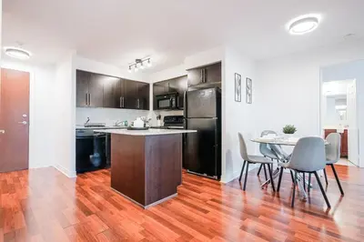 an empty kitchen with a table and chairs in a room at Elegant 2BR 2BA Condo Heart of Mississauga SQ1 in Mississauga