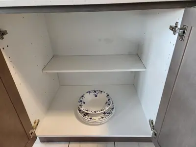 a bowl in a cabinet with a plate in it at Cozy Home for 10 people in Kitchener