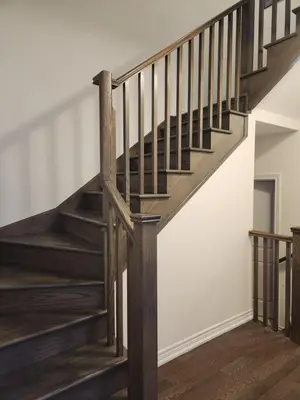 a wooden staircase in a home with white walls at Cozy Home for 10 people in Kitchener