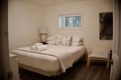 a bedroom with a bed with towels on it at Serendipity 5 BR Waterfront 4 Seasons, Hot Tub, Firepit, Close to Ski HIll in Haliburton