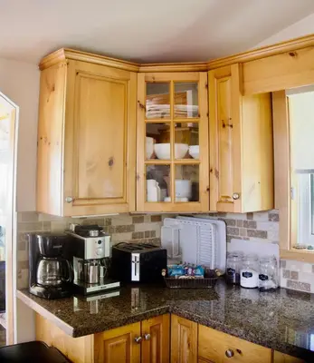 a kitchen with wooden cabinets and a counter top at Serendipity 5 BR Waterfront 4 Seasons, Hot Tub, Firepit, Close to Ski HIll in Haliburton