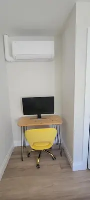 a desk with a yellow chair in a room at Bright Garden Suite 1 Bedroom and Den in Toronto
