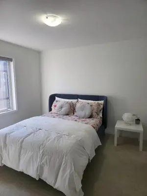 a bedroom with a bed with pillows on it at Modern Stylish Cozy Home Balcony Wifi in Caledonia