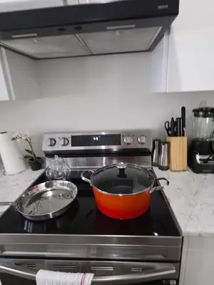 a pot on top of a stove in a kitchen at Modern Stylish Cozy Home Balcony Wifi in Caledonia