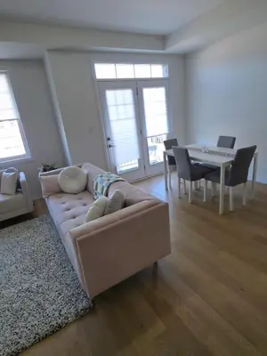 a living room with a couch and a table at Modern Stylish Cozy Home Balcony Wifi in Caledonia